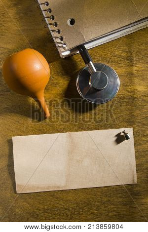 Stethoscope of a doctor in a notebook on a wooden table