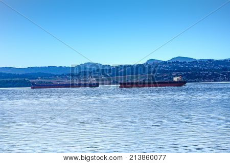 Massive freighters in the Strait of Juan de Fuca near British Columbia