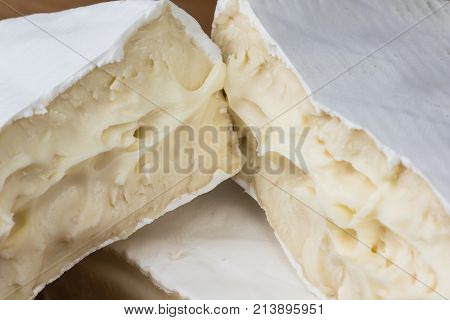 Close Up Of Camembert Cheese. Brie With Coarse Edge Broken Into Pieces Cremy And Delicious.