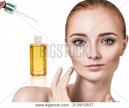 Cosmetic oil applying on young woman face with pipette. Beauty therapy concept.