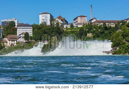 Neuhausen am Rheinfall, Switzerland - 22 June, 2016: the Rhine Falls waterfall in Switzerland in summer. The Rhine Falls (German: Rheinfall) is the largest plain waterfall in Europe.