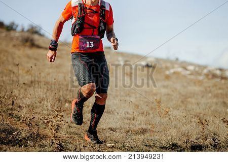 young male athlete runner running mountain trail