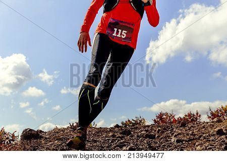 body of runner man running on background blue sky