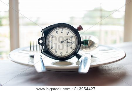 Retro stopwatch to put on plate. Weight loss for good Healthy. Diet is sum of food consumed by person or other organism. Time to diet concept.