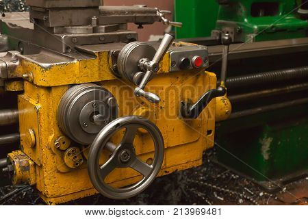 part of the old milling machine with levers yellow body metal parts