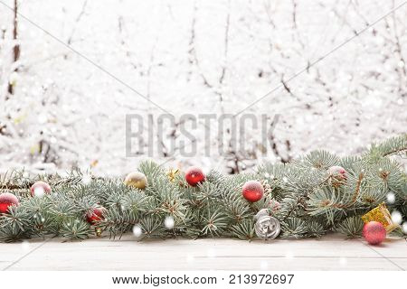 Christmas Fir Tree Garland On Wooden Board On Window Sill Over Nature Snowing Tree Park Background W