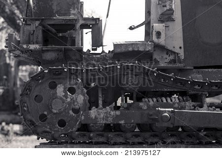 Backhoe is located in the construction site black and white.