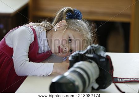 Belarus the city of Gomel May 16 2016 kindergarten Volotovskaya.Little girl looks at the camera images.To photograph children. Child photographer. Curious girl.Children and the camera
