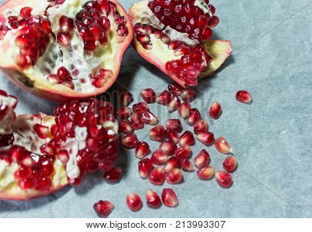 ripe pomegranate,clove, and pomegranate seeds with blurred background