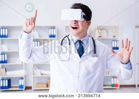 Young doctor with vr virtual reality headset working in the offi