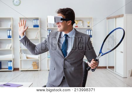 Businessman playing virtual reality tennis in office with VR gog