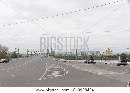 Nizhny Novgorod Russia. - October 03.2017. View of the Kanavinsky Bridge from the high shore side. Movement of cars on the bridge. The Cathedral of Alexander Nevsky and the football stadium under construction on the other side.