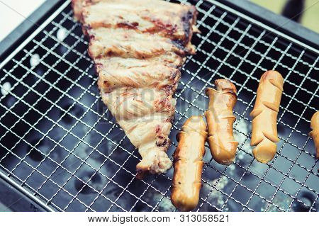 Close Up Grill With Meat And Sausage Ready For Socializing Celebrate At Outsite Home.