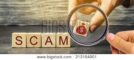 Businessman Puts Wooden Blocks With The Word Scam. Fraudulent Investment Project. Illegal Plan To Ge