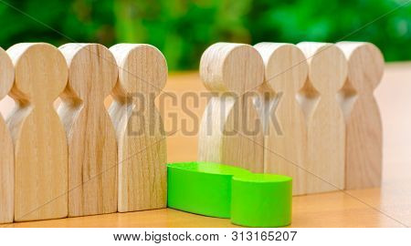 The Green Figure Of A Man Falls Out Of The Line Of People. Concept Of Employee Dismissal And Team Ma