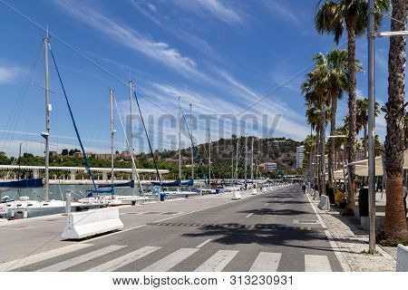 Malaga, Spain - May 24, 2019: View Of A Road And Yachts At The Paseo Del Muelle Uno, A Beachfront Sh