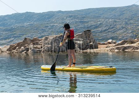 Stand Up Paddleboarding On Lake. Watersport On Lake. Tourist Outdoor Activity At Lagoa Comprida, Ser