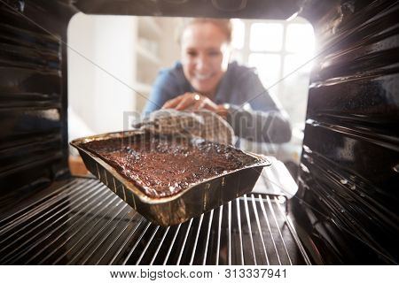 View Looking Out From Inside Oven As Woman Burns Dinner