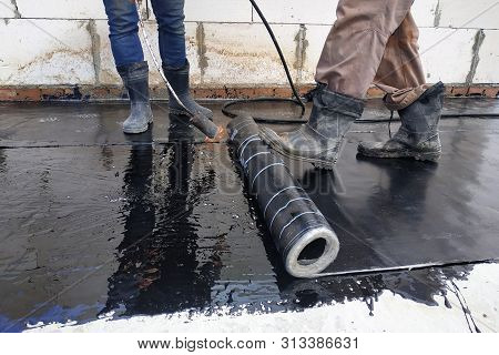 The Workers Cover The Concrete Screed With Bituminous Liquid Solution And Stele The Waterproofing.