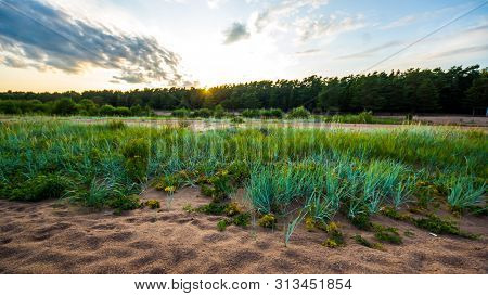Sandy Beach And Sunset At The Bay