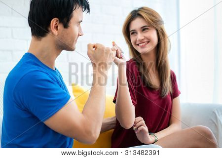 Couple Hands Show Little Finger On Sofa In House. Romantic Love Concept. Hand To Pinky Swear, Pinky 