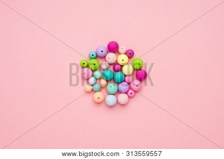 Colorful Pastel Beads In A Circle On Pink Background. Girly Minimalist Composition