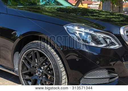 Novosibirsk, Russia - 07.20.2019: Black Mercedes Benz E-class E350 2013 Year Front Wheel And Headlig