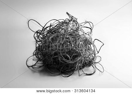 Unorganized mess. Tangled, stress, confused, complicated, concept image. Large ball of tangled and hemp string isolated on neutral white background.