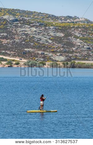 Stand Up Paddleboarding On Lake. Watersport On Lake. Tourist Outdoor Activity At Lagoa Comprida, Ser