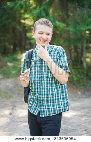 Teenager Boy With Mushroom In The Forest In Summer Day