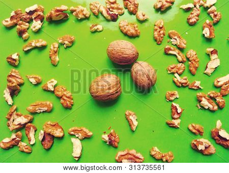 Ripe Walnuts Lie On A Gentle Green Background. Healthy Food For People