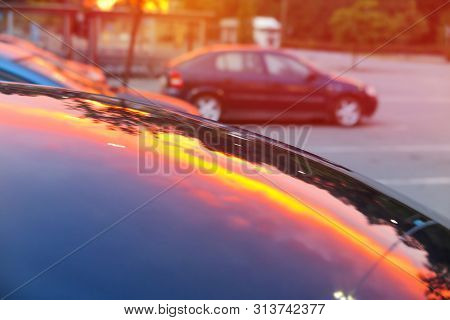 Pink Sunset Mirrored Reflection On A Metal Car Capote Creating Abstract Composition With With Blurre