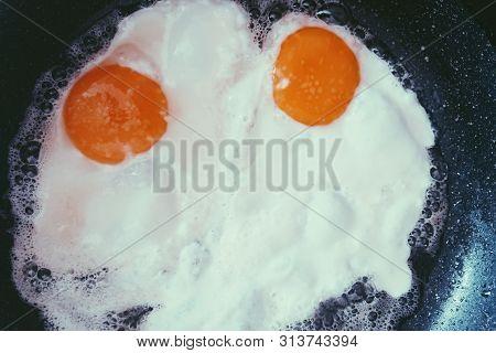 Eggs Are Fried In A Pan At Home For Breakfast