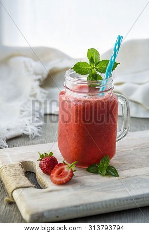 Photo Of Strawberry Smoothie In Jar With Straw On Light Background. Fresh Organic Smoothie. Health O