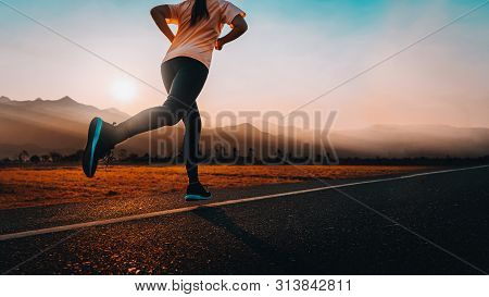 Young Asian Woman Enjoys Running Outside With Beautiful Summer Evening In The Countryside.