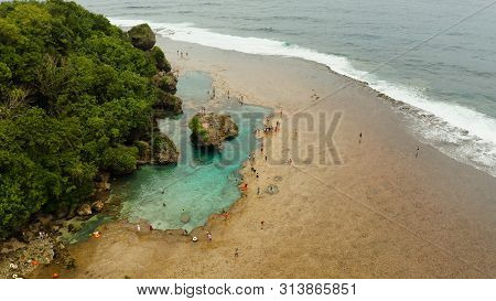 Rocky Shore At Low Tide With Swimming Pools And Tourists. Magpupungko Natural Rock Pools. Siargao, P