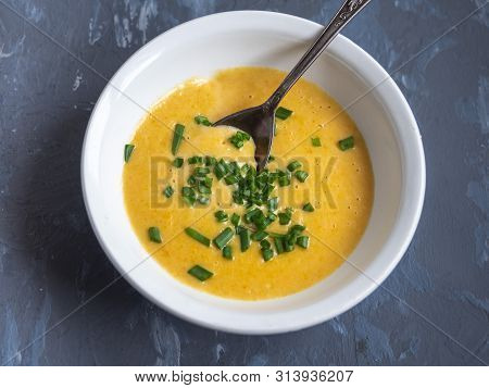 Soup Of Mashed Potatoes With Vegetables And Cheese Sprinkled With Green Onions In A Deep White Plate