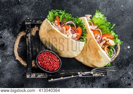 Doner Kebab With Grilled Chicken Meat And Vegetables In Pita Bread On A Wooden Tray. Black Backgroun