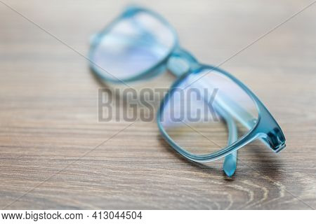 Eyeglassed Blue Color On Wooden Table Office