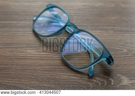 Eyeglassed Blue Color On Wooden Table Office