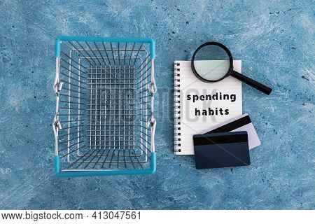 Spending Habits Text On Notepad With Shopping Basket And Magnifying Glass And Payment Cards, Money A