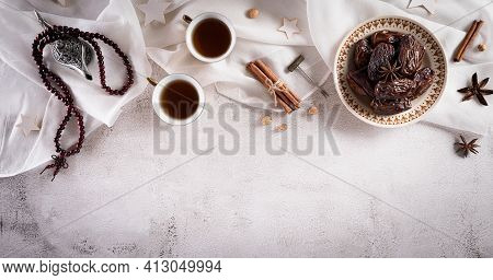 Ramadan Food And Drinks Concept. Ramadan Arabian Lamp, Wood Rosary, Tea, And Dates Fruit On Dark Sto