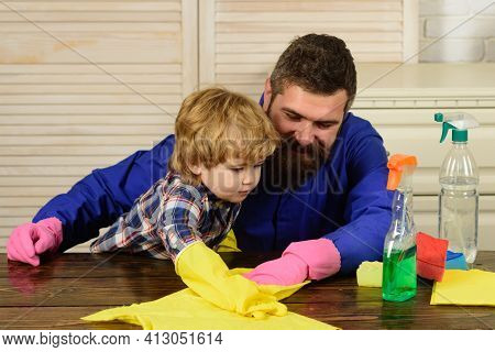 Father And Son Cleaning. Man Accustoms The Boy To Cleanliness