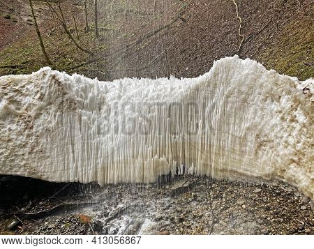 The Last Spring Remnants Of Frozen Winter Snow Under The Sulzigbachfall Waterfall In The Sulzigtobel