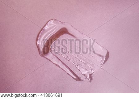 A Drop Of Transparent Cosmetic Gel On A Pink Background