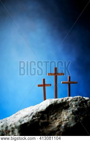 Three Wooden Cross On Calvary Hill, Blue Background. Crucifixion, Resurrection Of Jesus Christ. Chri