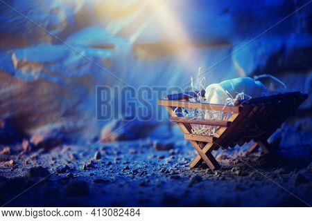 Christian Christmas Concept. Birth Of Jesus Christ. Wooden Manger In Cave Background. Banner, Copy S