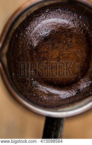 Making black coffee in cezva for the breakfast at the early morning. Top view