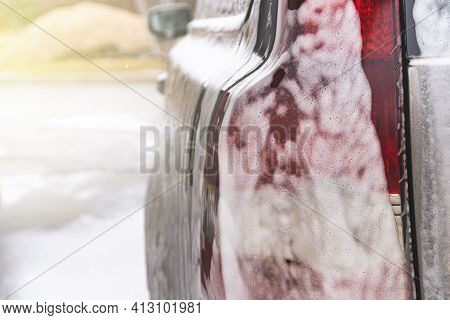 Car Covered With Washing Foam At Contactless Car Washing Service