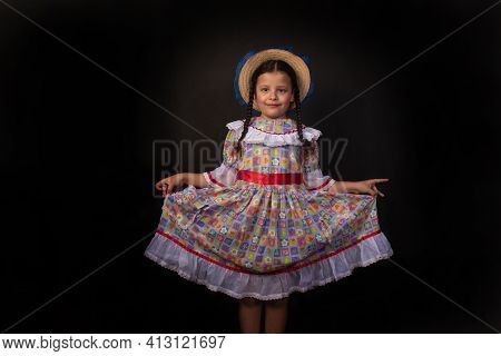 Festa Junina In Brazil, Brazilian Girl With Braids And Dressed For Junina Party With Straw Hat Doing